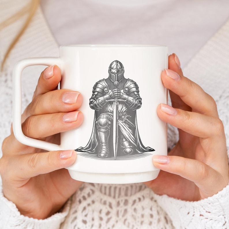 May include: White ceramic mug with a black and white illustration of a knight kneeling with a sword. The knight is wearing armor and a helmet.
