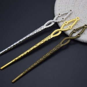 May include: Three decorative hair sticks with intricate designs. The sticks are silver, gold, and bronze in color. They are twisted and have a floral pattern.