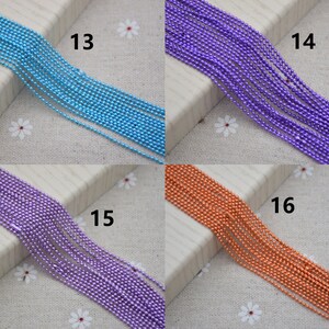 May include: Four rows of different colored metal chains. The chains are light blue, purple, purple, and orange. The chains are numbered 13, 14, 15, and 16.