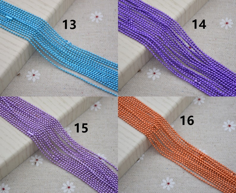 May include: Four rows of different colored metal chains. The chains are light blue, purple, purple, and orange. The chains are numbered 13, 14, 15, and 16.