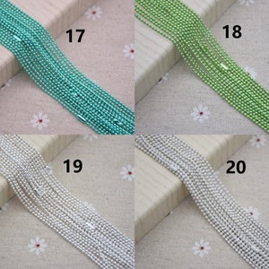 May include: Four spools of chain, each with a different color: turquoise, green, silver, and white. The spools are labeled 17, 18, 19, and 20.