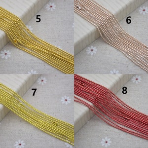 May include: A close-up of four different colored chains. The chains are made of small, round beads. The chains are arranged in rows, with the numbers 5, 6, 7, and 8 printed next to each row.