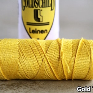 May include: A spool of bright yellow thread, labelled "Gold Yellow".