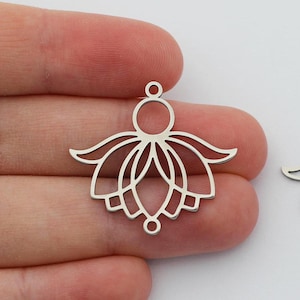 May include: Two silver-coloured metal lotus flower charms. Each charm has a detailed openwork design with a circular top, a central flower shape, and three lower attachment points. Ideal for jewellery making.