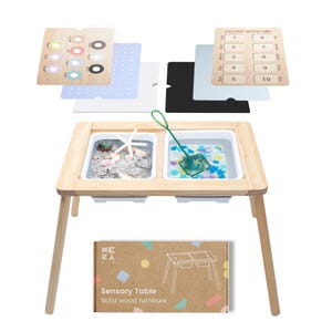 May include: A wooden sensory table with two white trays, one filled with sand and seashells, the other with water and colorful beads. A green net is in the water tray. The table has a brown box with the text "Sensory Table" and "Solid wood furniture".