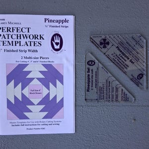 May include: A white and purple Perfect Patchwork Templates booklet with two clear plastic Pineapple Set templates. The booklet features a pineapple quilt block design and text. The templates are for 1/2" finished strip width.