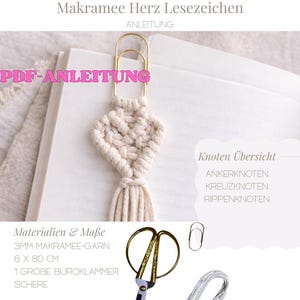 May include: A macrame heart bookmark with a gold paperclip, displayed on a book. The bookmark is made of cream-colored yarn and has a tassel. The image also shows scissors, yarn, and text that reads "PDF-ANLEITUNG".