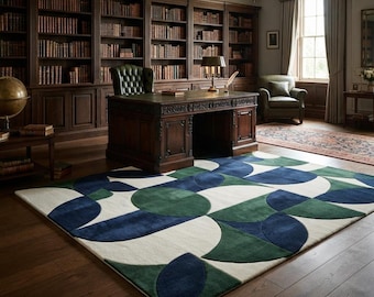 May include: A rectangular area rug featuring a geometric pattern of large circles and semi-circles in deep navy blue, forest green, and cream. The rug is positioned on a dark hardwood floor in a library setting with wooden bookshelves and furniture.