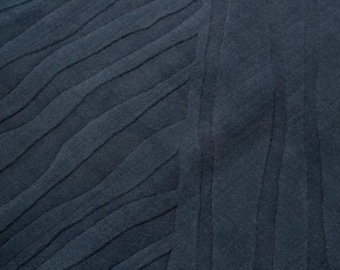 May include: A dark blue textured fabric with a wavy pattern.