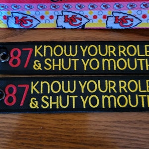 May include: Two black keychains with a red number 87 and yellow text that reads "Know Your Role & Shut Yo Mouth".