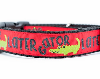 May include: Red dog collar with black text that reads "See Ya Later Gator" and a green alligator graphic.