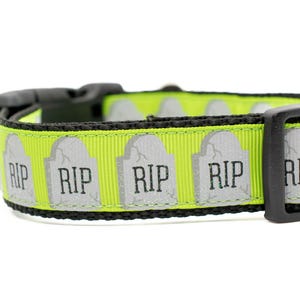May include: A lime green dog collar with a black buckle and a repeating pattern of gray tombstones with the word "RIP" printed on them.