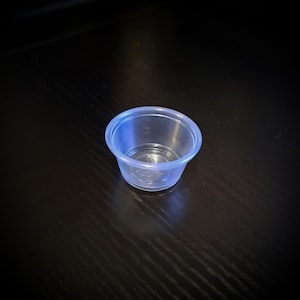May include: A clear plastic condiment cup, ideal for serving small portions of sauces, dips, or dressings.