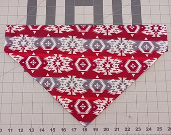 May include: Red, white and grey patterned bandana with a geometric design. The bandana is folded into a triangular shape.