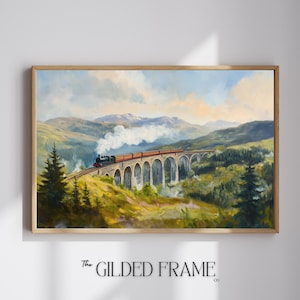 May include: A framed landscape painting depicts a train crossing a stone bridge over a valley. The train is red and black, with white smoke billowing from the engine. The artwork is set against a backdrop of green hills and a cloudy sky.