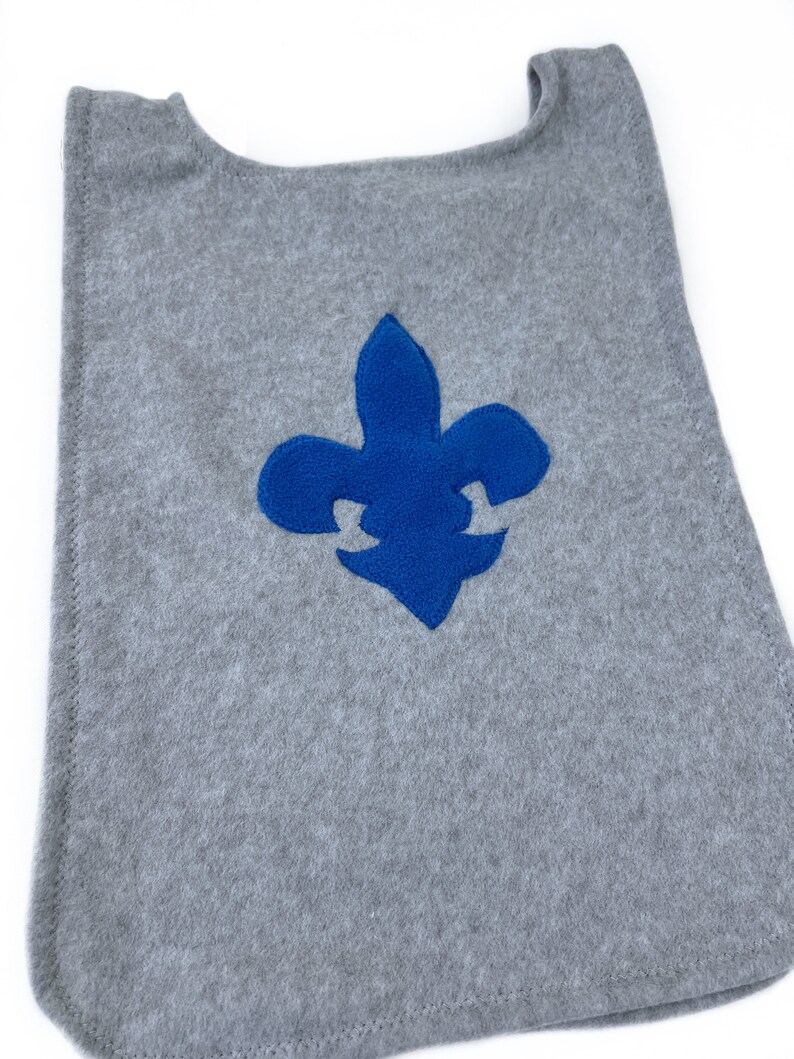 May include: Gray fleece fabric cape with a blue felt fleur-de-lis emblem.