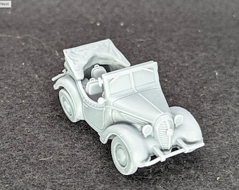 May include: A gray miniature vintage convertible car with a fabric top. The model car has detailed features including headlights, a front grill, and interior seats. The car is a classic design, likely from the early to mid-20th century.