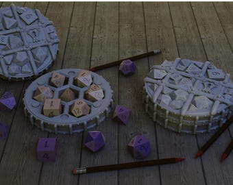 May include: A collection of dice and dice containers, with pencils. The dice are various shapes and colors, including purple and tan. The containers are gray and round, with a grid-like design. The pencils are brown with red erasers.