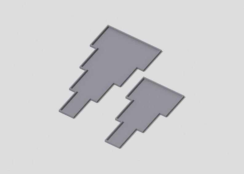 May include: Two gray, tiered, geometric shapes, resembling a staircase, are arranged in a staggered pattern. The shapes are made of a smooth, solid material.