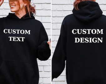May include: Black hoodie with the text "CUSTOM TEXT" on the front and "CUSTOM DESIGN" on the back. The hoodie has a hood and a front pocket. The person in the image is wearing a black and white trucker hat.