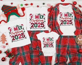 May include: A festive family Christmas pajama set. The image shows white t-shirts, a baby onesie, and red plaid trousers. Each garment is printed with "FAMILY Christmas 2025". A matching Christmas hat is also visible, creating a coordinated look.