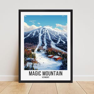 May include: A framed print featuring a winter landscape of Magic Mountain in Vermont. The artwork depicts a snow-covered mountain with ski trails, red-roofed buildings, and a bright blue sky. The words "MAGIC MOUNTAIN VERMONT" are printed at the bottom.