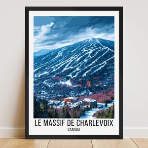 May include: A framed print of Le Massif de Charlevoix, Canada, showing a snow-covered mountain with ski slopes. The artwork depicts a winter landscape with a blue sky, trees, and buildings at the mountain's base. The text "LE MASSIF DE CHARLEVOIX CANADA" is at the bottom.