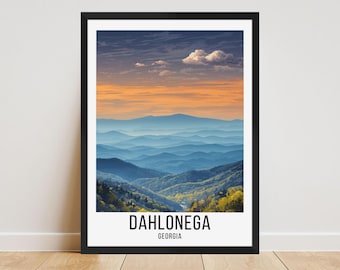 May include: A framed art print featuring a scenic mountain landscape with layers of blue-toned hills under a vibrant orange and blue sky. The text "DAHLONEGA GEORGIA" is displayed at the bottom of the print.