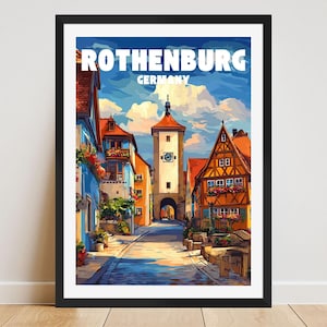 May include: A framed art print of Rothenburg, Germany. The artwork shows a vibrant street scene with buildings in blue, orange, and brown. The text "ROTHENBURG GERMANY" is at the top of the print.