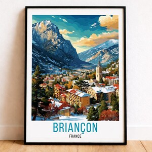 May include: Framed art print of Briançon, France, featuring a colorful illustration of a mountain town nestled in a valley. The artwork showcases snow-capped mountains, buildings with red roofs, and the text "BRIANÇON FRANCE" at the bottom.
