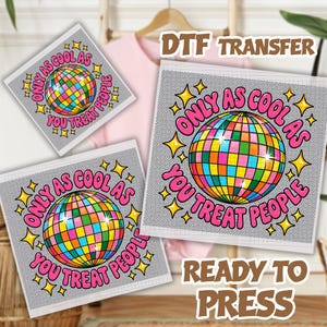 May include: A DTF transfer sheet featuring a colorful disco ball graphic surrounded by yellow stars and the pink text "ONLY AS COOL AS YOU TREAT PEOPLE". The design is set against a gray grid background, presented in multiple sizes for garment application.