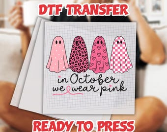 May include: DTF transfer featuring four pink ghost designs with various patterns, including polka dots, leopard print, hearts, and a checkered pattern. The text "in October we wear pink" is also included. The words "READY TO PRESS" are also visible.