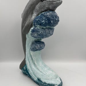 Dolphin riding a wave cast stone statue