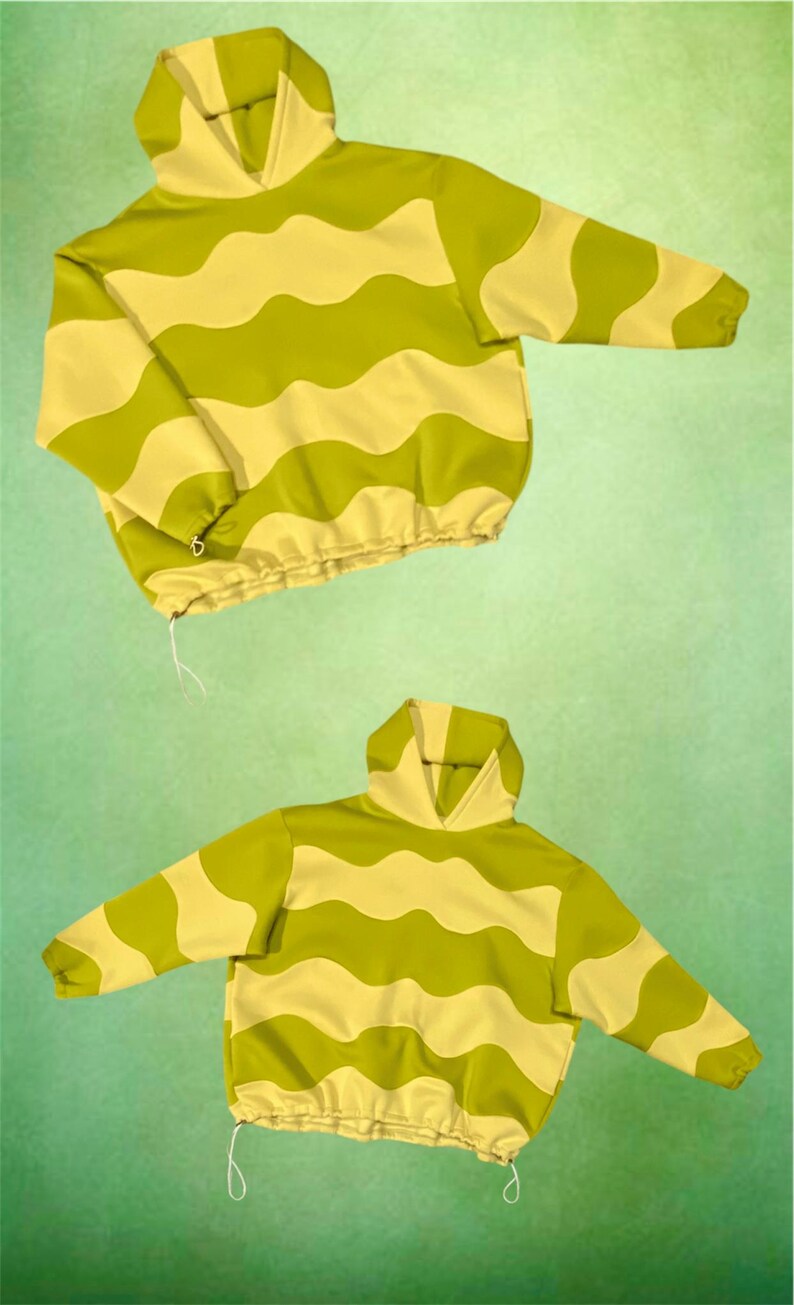 May include: Two hooded sweatshirts with a wavy pattern in shades of green and yellow. The sweatshirts have long sleeves, a drawstring at the waist, and a hood. The background is a solid green color.