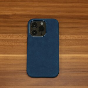 May include: A dark blue phone case with a camera lens cutout.