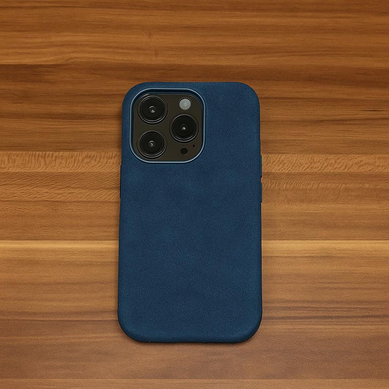 May include: A dark blue phone case with a camera lens cutout.