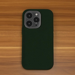 May include: A dark green phone case with a camera lens cutout. The case is made of a soft, textured material.