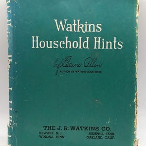 May include: A vintage teal-colored book titled "Watkins Household Hints" by Elaine Allen. The cover features white text and the author's signature. The book is published by The J.R. Watkins Co. with locations in Newark, Winona, Memphis, and Oakland.