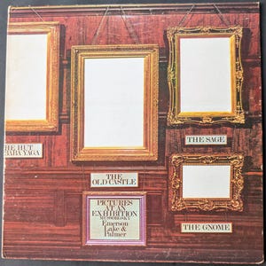 May include: Album cover featuring a series of ornate, empty picture frames against a dark wood-paneled wall. Text includes "Pictures at an Exhibition" and song titles like "The Old Castle" and "The Gnome."