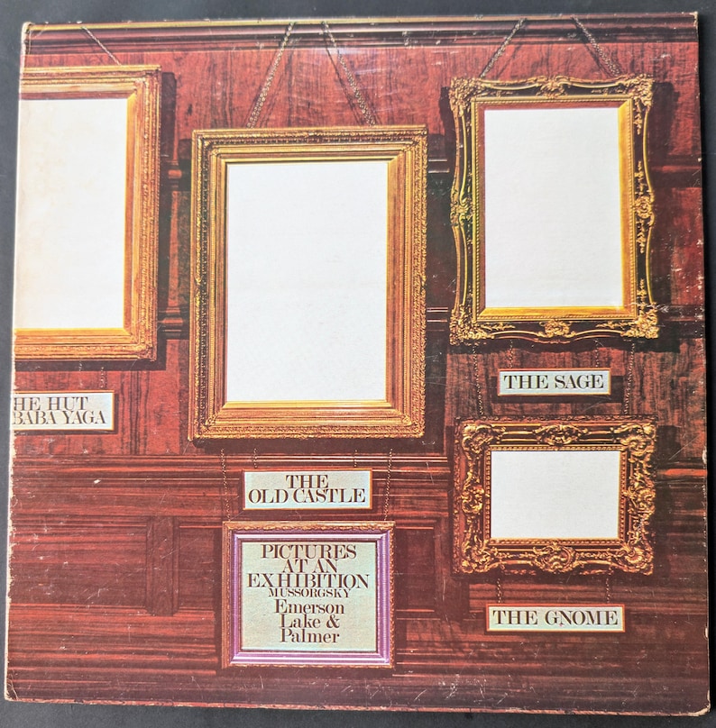 May include: Album cover featuring a series of ornate, empty picture frames against a dark wood-paneled wall. Text includes "Pictures at an Exhibition" and song titles like "The Old Castle" and "The Gnome."
