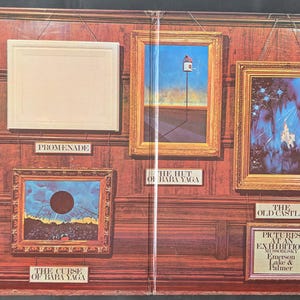 May include: A collection of framed art pieces, including paintings and a blank frame, displayed on a wood-paneled wall. The art features various styles and subjects, with labels identifying each piece. The overall theme is an art exhibition.