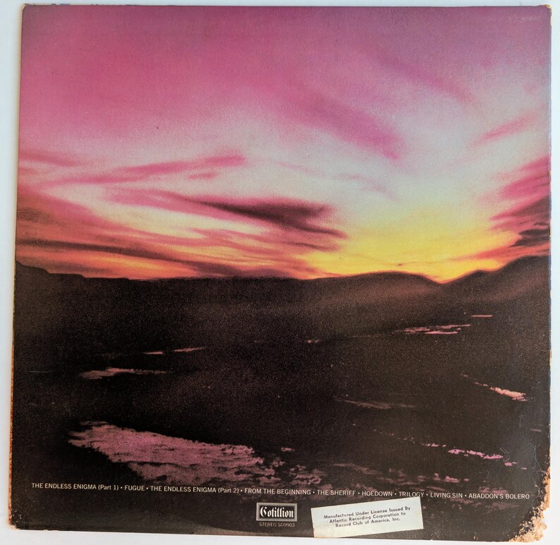 May include: Album cover featuring a vibrant sunset over a dark landscape. The sky transitions from pink to yellow, with the album title and track names listed at the bottom. The Cotillion logo is also visible.