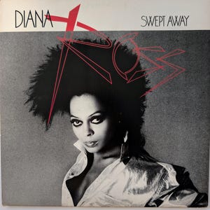 May include: Album cover for Diana Ross's "Swept Away." The cover features a black and white image of Diana Ross with bold red text overlay. The album title and artist's name are displayed prominently.