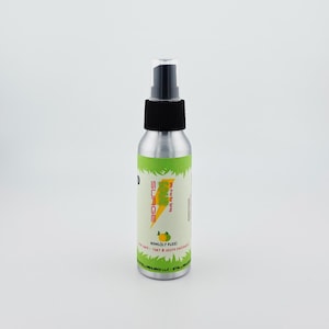 May include: A silver spray bottle with a black nozzle and cap. The label features the word "SURGE" in yellow, a lightning bolt graphic, and the text "The Fine Air Spray". The bottle contains 80ml (2.7 fl oz) of product.