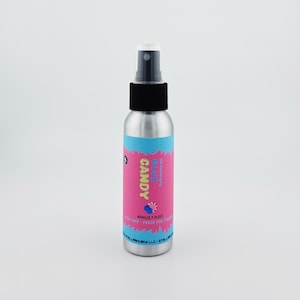 May include: A silver spray bottle with a black cap and a pink and blue label. The label reads "CANDY Blue Razz" with a graphic of a blue candy. The bottle contains 50ml (1.7 fl oz) of product.