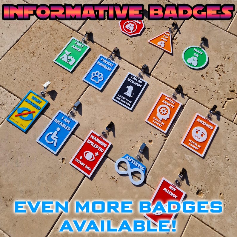 May include: A collection of informative badges with various designs and text, including "First Aider," "Pursuit Handler," "I Am An Introvert," and "I Am Disabled." The badges are in various colors and shapes, with a clip for attachment. The text "Informative Badges" and "Even More Badges Available!" are also visible.