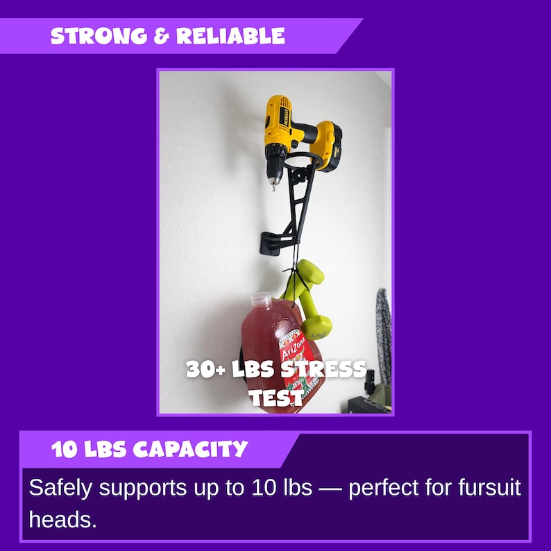 May include: Black metal wall-mounted drill holder with a yellow and black drill attached. A red container and green dumbbells hang from the holder. Text reads "STRONG & RELIABLE" and "30+ LBS STRESS TEST".