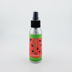 May include: A silver spray bottle with a black nozzle and cap. The label features a watermelon design with red, green, and black colors. The text "WATERMELON" is printed vertically on the label. The bottle contains 80ml (2.7 fl oz).