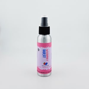 May include: A silver spray bottle with a black cap and a pink and purple label. The label reads "Wildberry Burst" with a strawberry and blueberry graphic. The bottle contains 80ml (2.7 fl oz) of product.