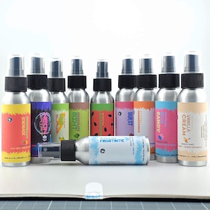 May include: A collection of aluminum spray bottles with black caps and colorful labels. Flavors include Lemonade, Neon Drift, Surge, Mint, Chocolate, Watermelon, Burst, Orange, Candy, Vanilla Cream, and Frostbite.